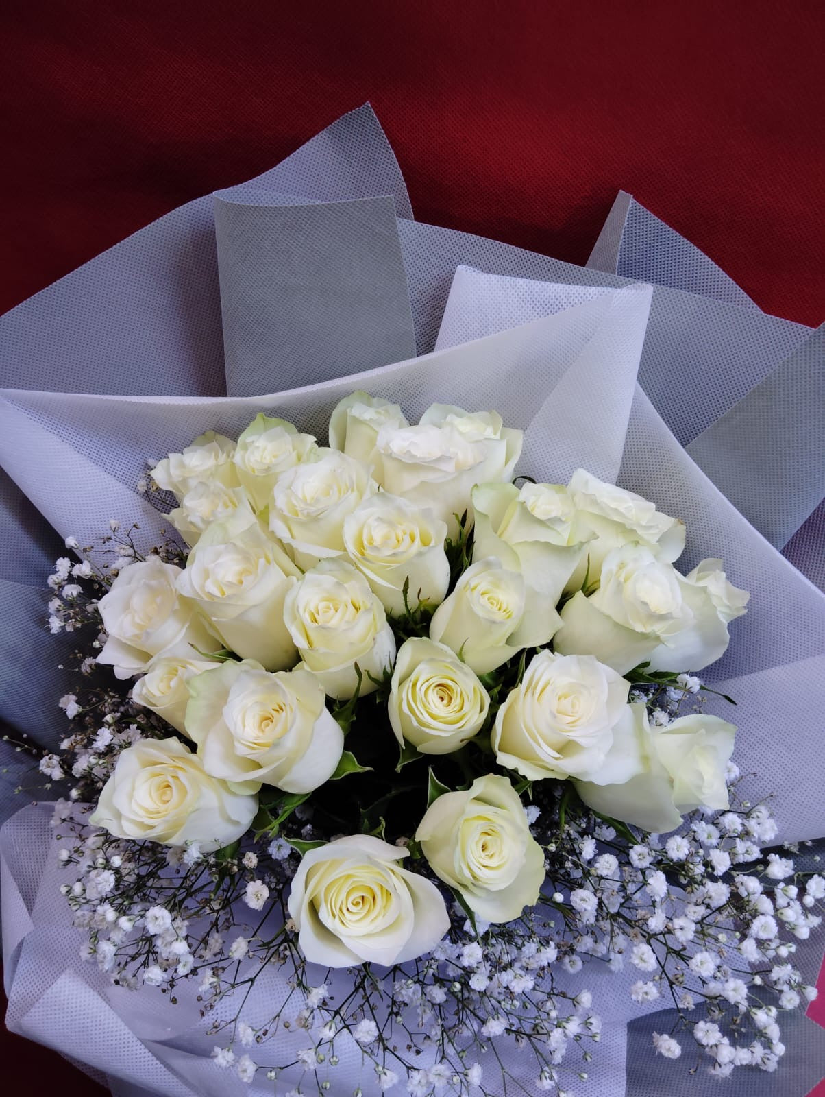 24 White Roses In Silver Wrapping