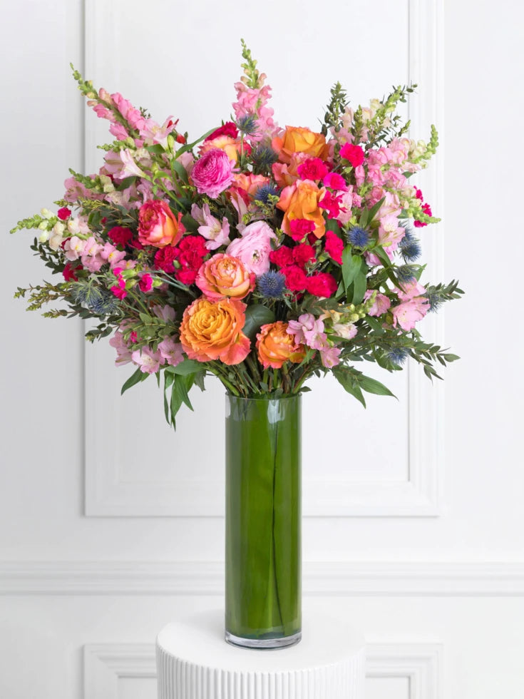 Bright Flowers In Cylindrical Vase